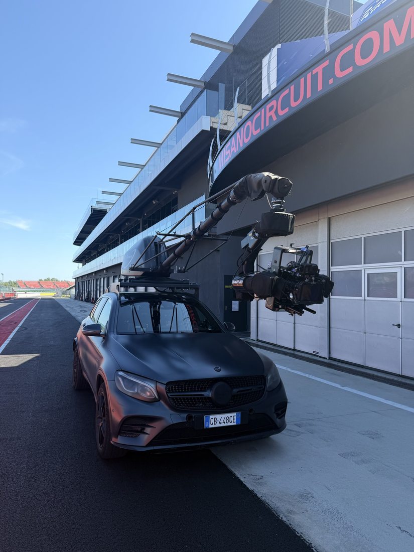 Camera car with crane arm on a race circuit