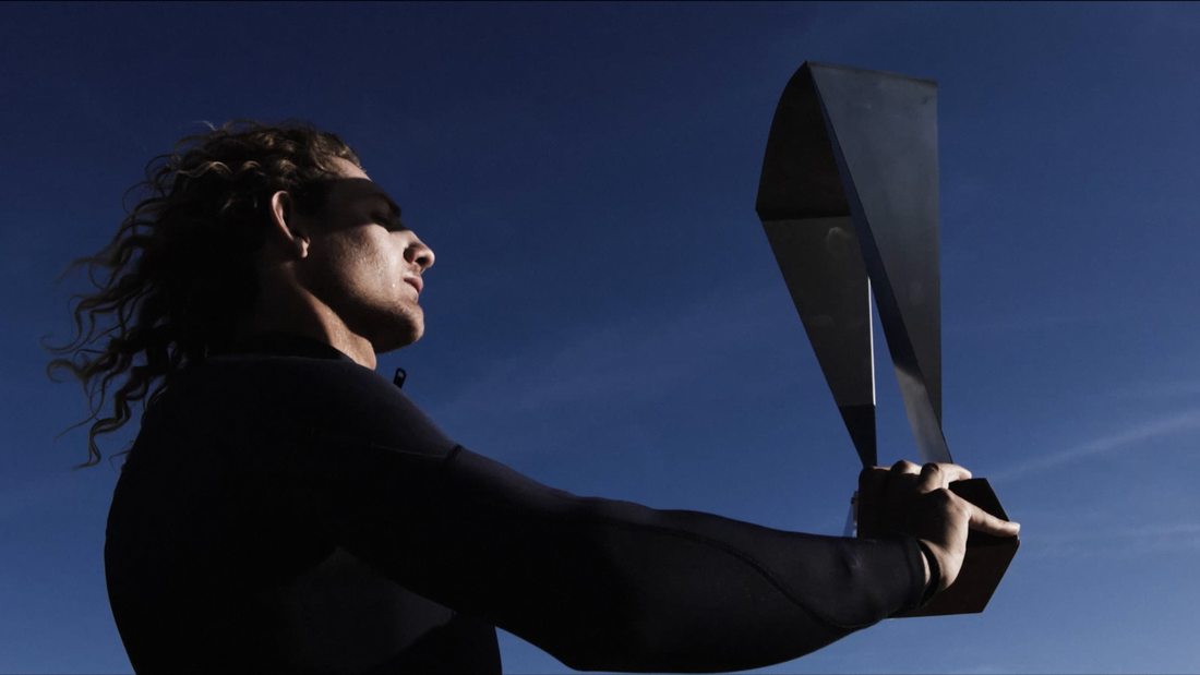 Holding the trophy against the sky